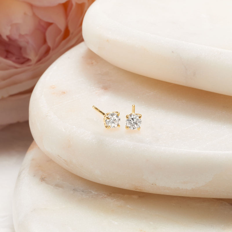 Yellow gold diamond stud earrings with round stones and short bar posts
