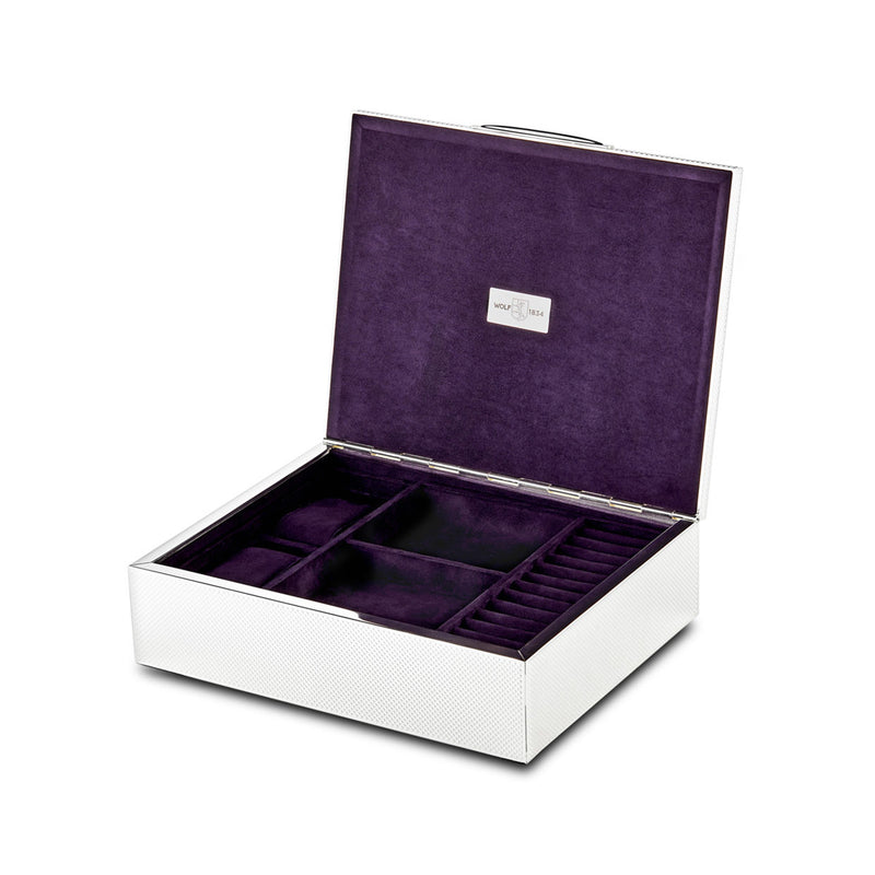 Silver tone jewelry box with hinged lid, open with purple velvet compartments and slots
