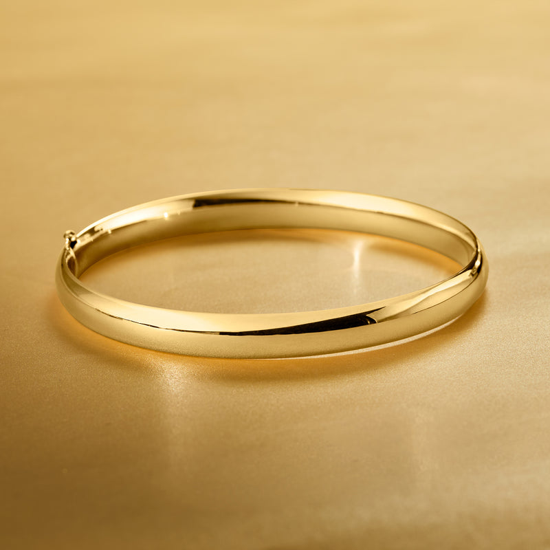 Polished yellow gold bangle bracelet, smooth round cuff with hollow interior