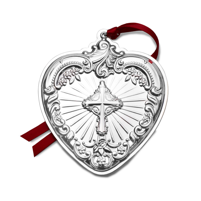 Sterling silver heart ornament with baroque detailing, hanging red ribbon and central cross