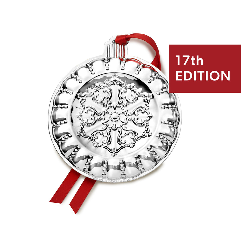 Sterling silver Christmas ornament with red ribbon and ornate scrollwork medallion