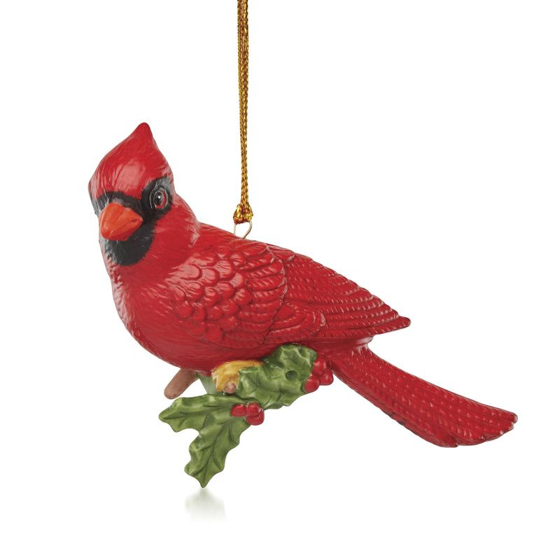 Red porcelain cardinal Christmas ornament with holly leaves and gold hanging cord