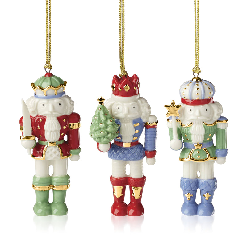 Three-piece porcelain nutcracker ornament set, hanging figures in red, green, and blue with gold trim