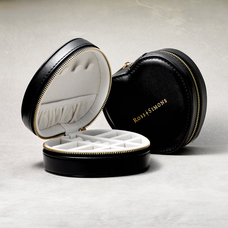 Heart-shaped jewelry travel case, one open with compartments and one closed with gold logo