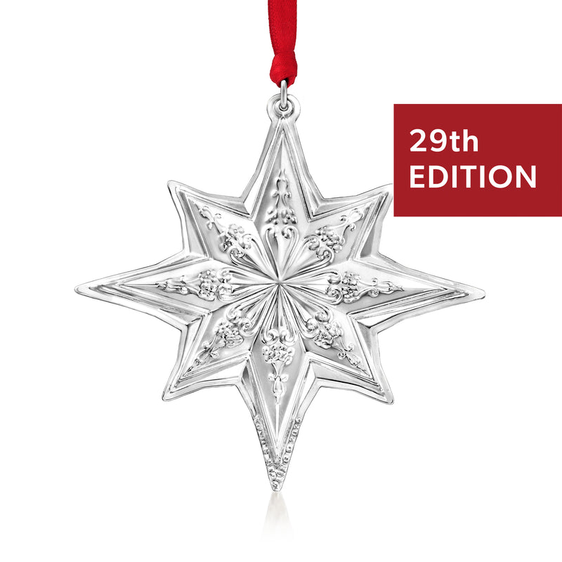 Towle sterling silver star ornament, 29th edition, hanging on red ribbon
