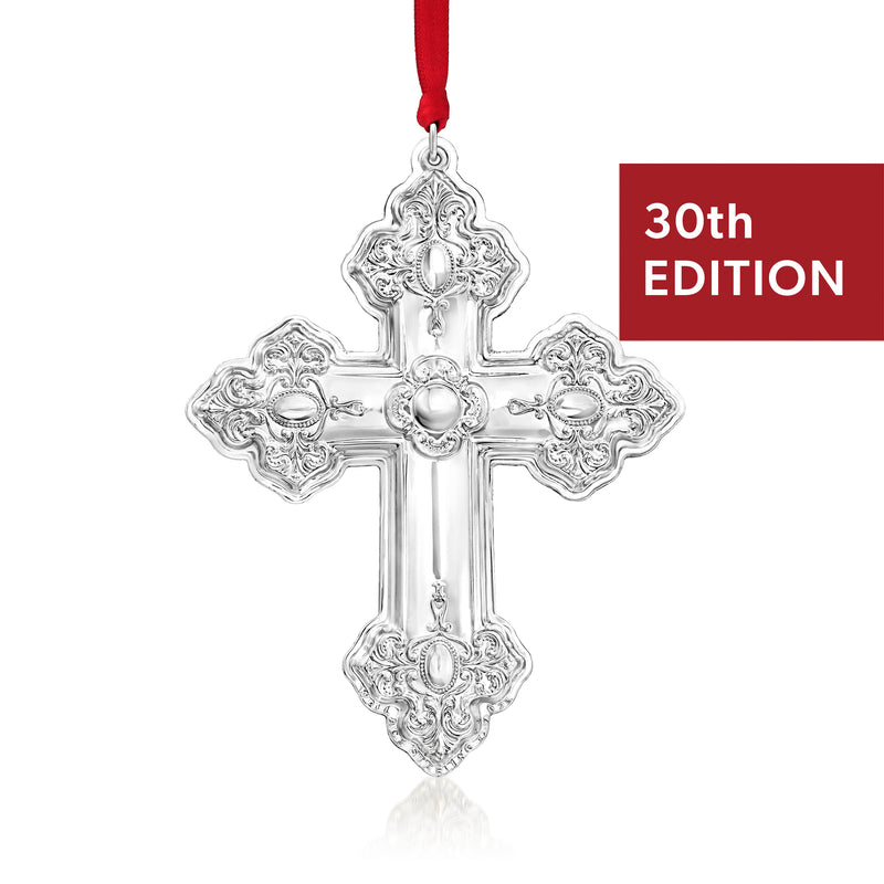 Ornate sterling silver cross ornament with hanging red ribbon