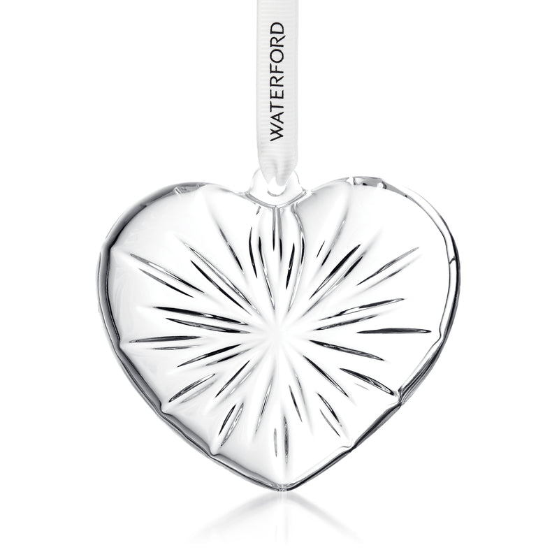Clear crystal heart ornament with polished facets and ridged rays, hanging with ribbon loop