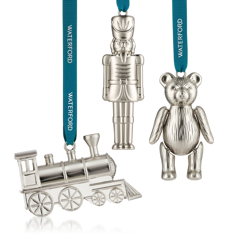 Set of three silvertone crystal ornaments: train, toy soldier, and teddy bear with teal ribbons