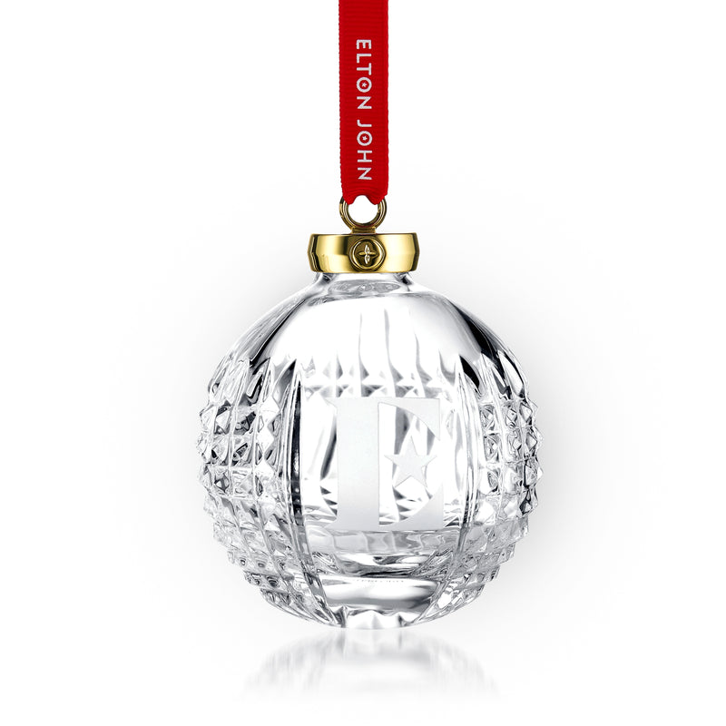 Clear crystal round bauble ornament with faceted cuts, red hanging ribbon, and gold cap