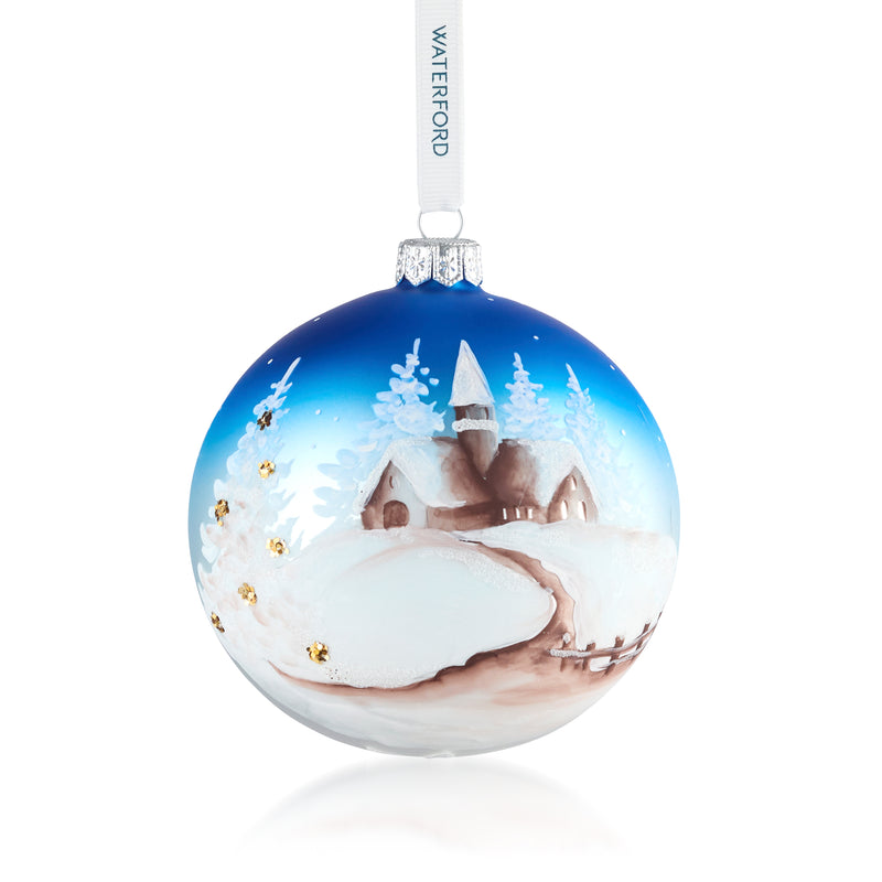 Waterford Crystal glass winter scene ornament with snowy cabin and trees, blue globe