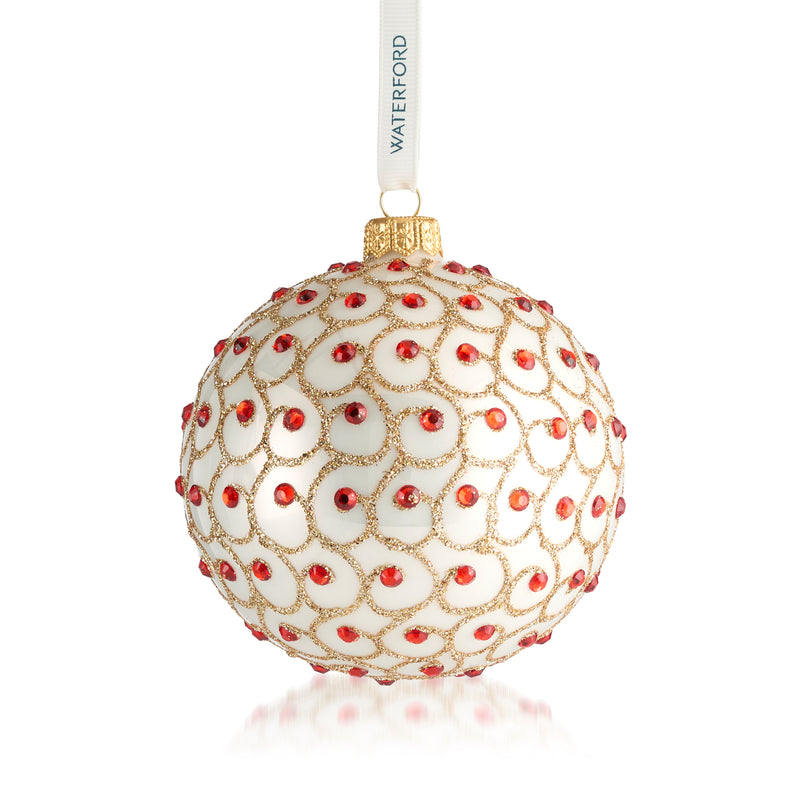 Round glass Christmas ornament with red bead-like accents and hanging ribbon
