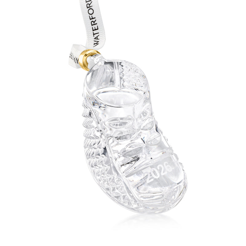 Clear crystal baby boot ornament with 2026 engraving, gold cap, and hanging ribbon