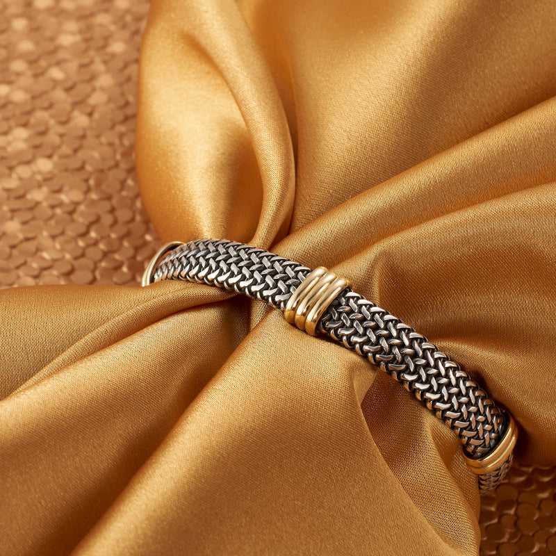 Woven sterling silver bracelet with paired gold accent rings on the chain