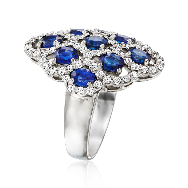 Platinum ring with oval blue sapphires and diamond clusters