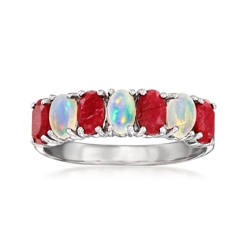 Sterling silver ring with oval opal center, red ruby side stones, small clear accents