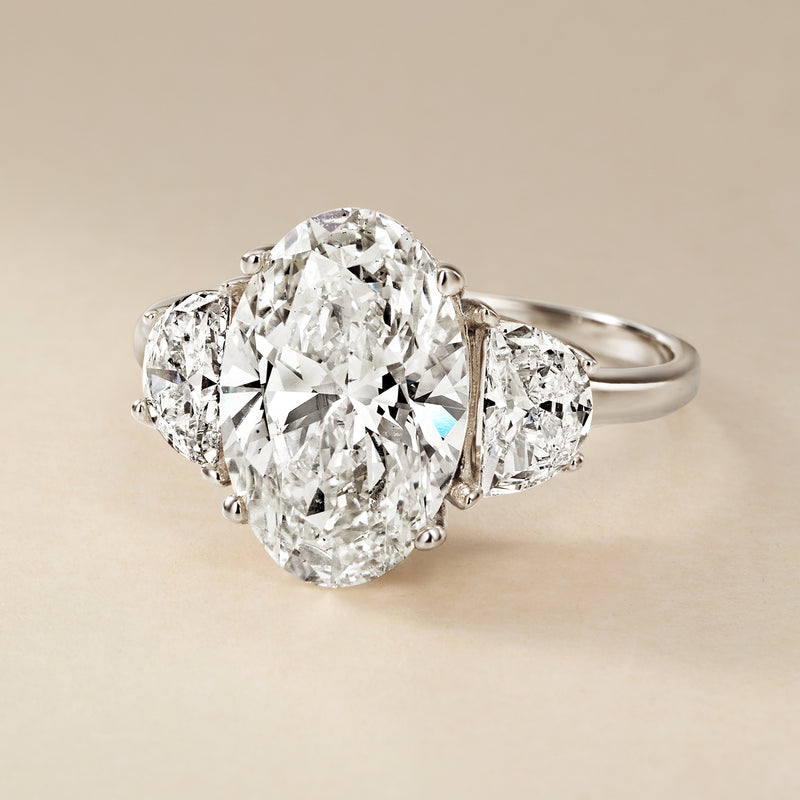 Three-stone lab-grown diamond ring in 14kt white gold with oval center and side stones