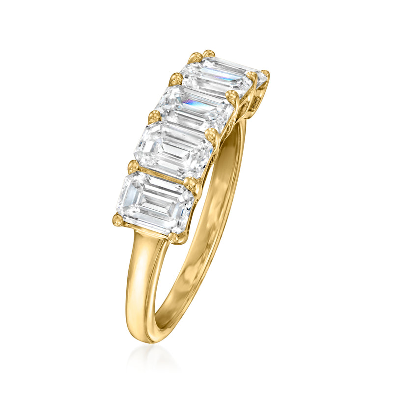 Side view of emerald-cut diamond ring with yellow gold prong settings