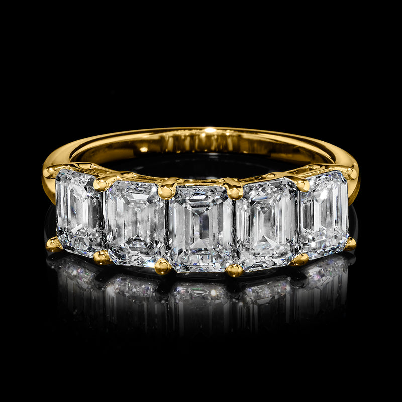 Five-stone emerald-cut diamond ring with yellow gold band and prong-set center stone