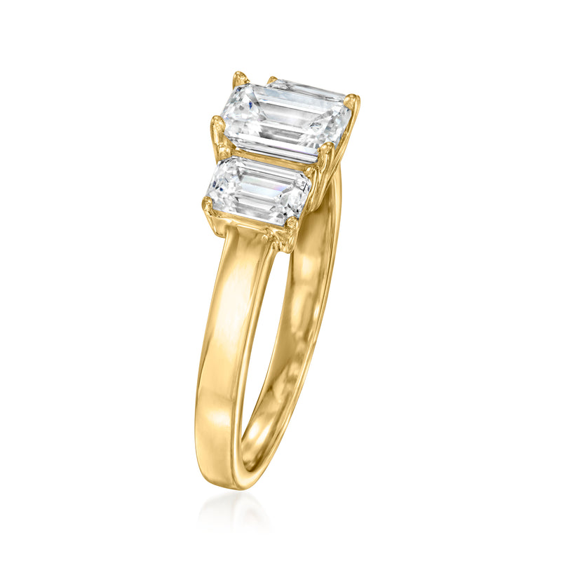 Three-stone emerald-cut diamond ring in 14kt yellow gold, angled side view