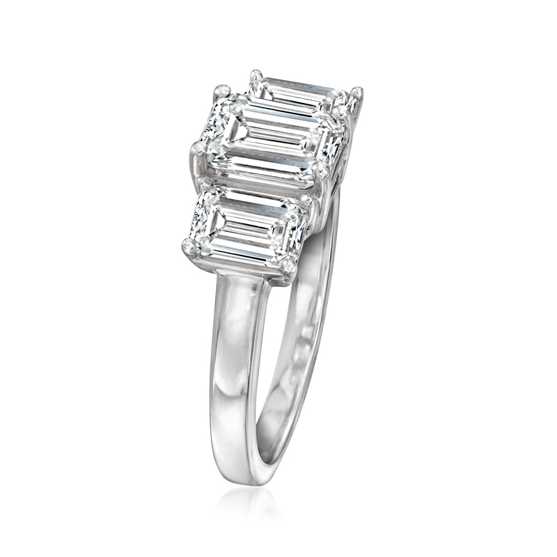 Three-stone emerald-cut diamond ring, angled view in 14kt white gold band