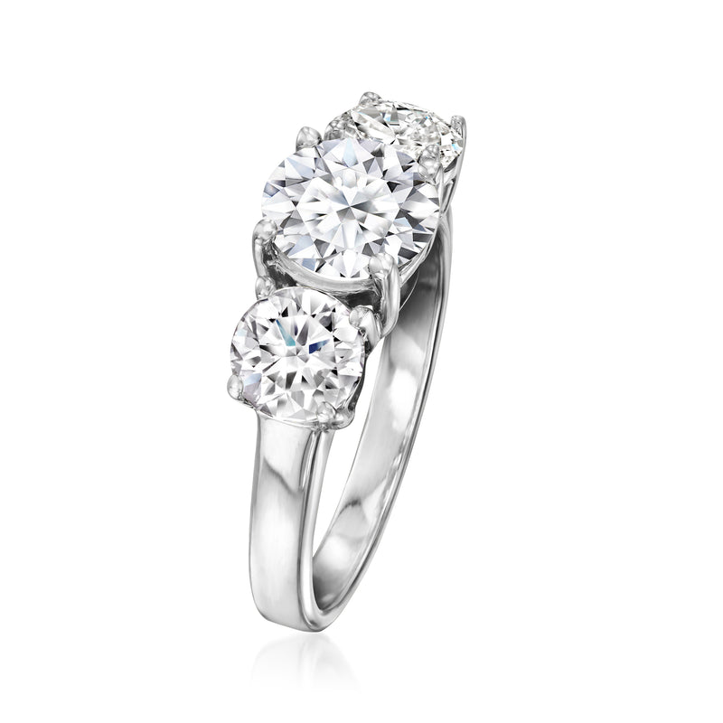 Three-stone diamond ring with large oval center and two round side stones, white gold