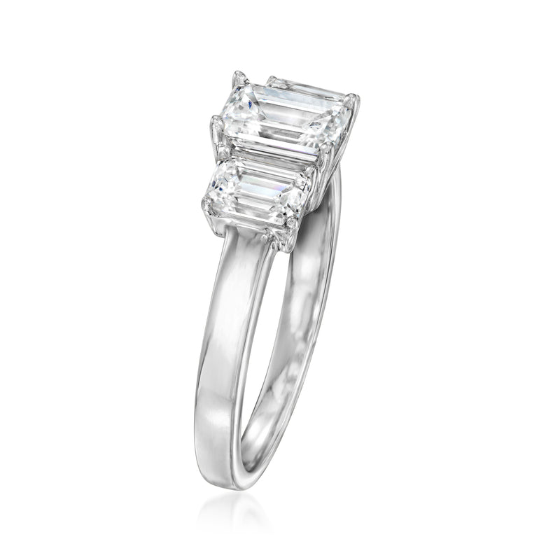Three-stone emerald-cut diamond ring in 14kt white gold, angled view of setting.