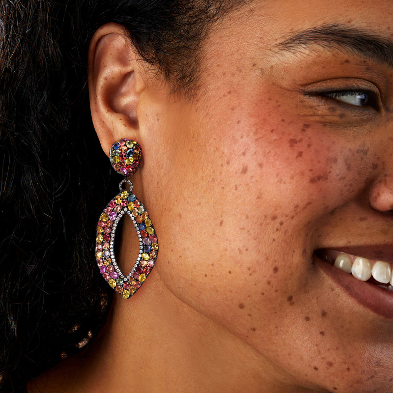 Multicolored gemstone and diamond clip-on drop earrings on ear, oval hoop design in white gold