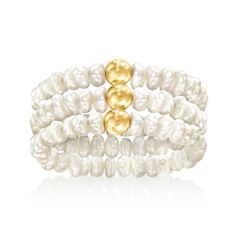 Three cultured pearl stretch rings with yellow gold domes, stacked view