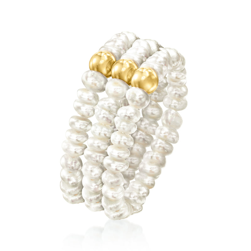 Cultured pearl stretch ring with yellow gold circular domes, angled view