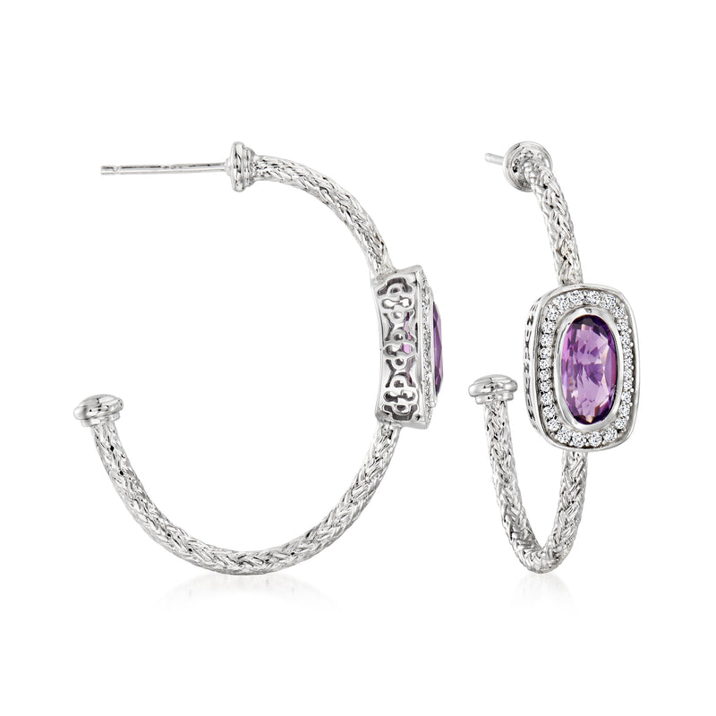 Sterling silver hoop earrings with oval amethyst-colored gemstone and crystal halo detail