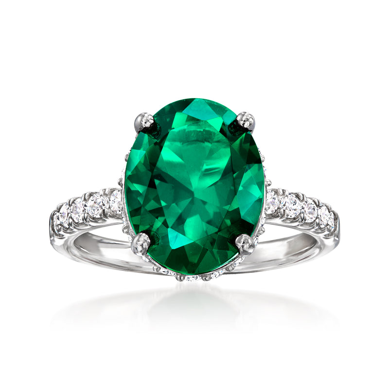 Sterling silver ring with oval green simulated emerald and white CZ accents