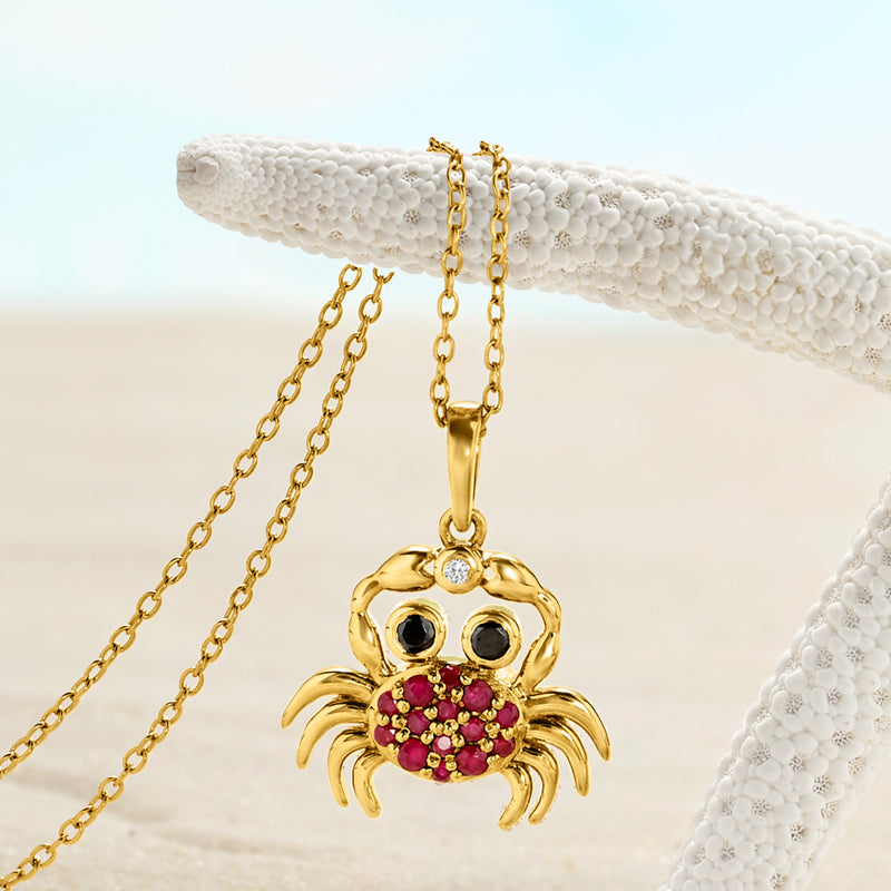 Gold crab pendant with ruby-red shell stones, black eyes, and small diamond accent
