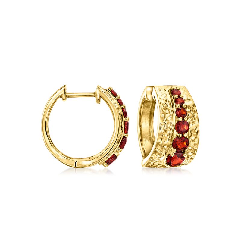 Hammered gold hoop earrings with red garnet stones, hinged clasp.