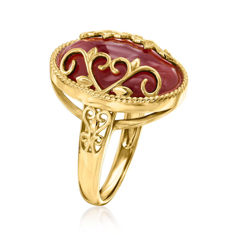 Gold-tone heart-scroll ring with red oval gemstone, side view of shank