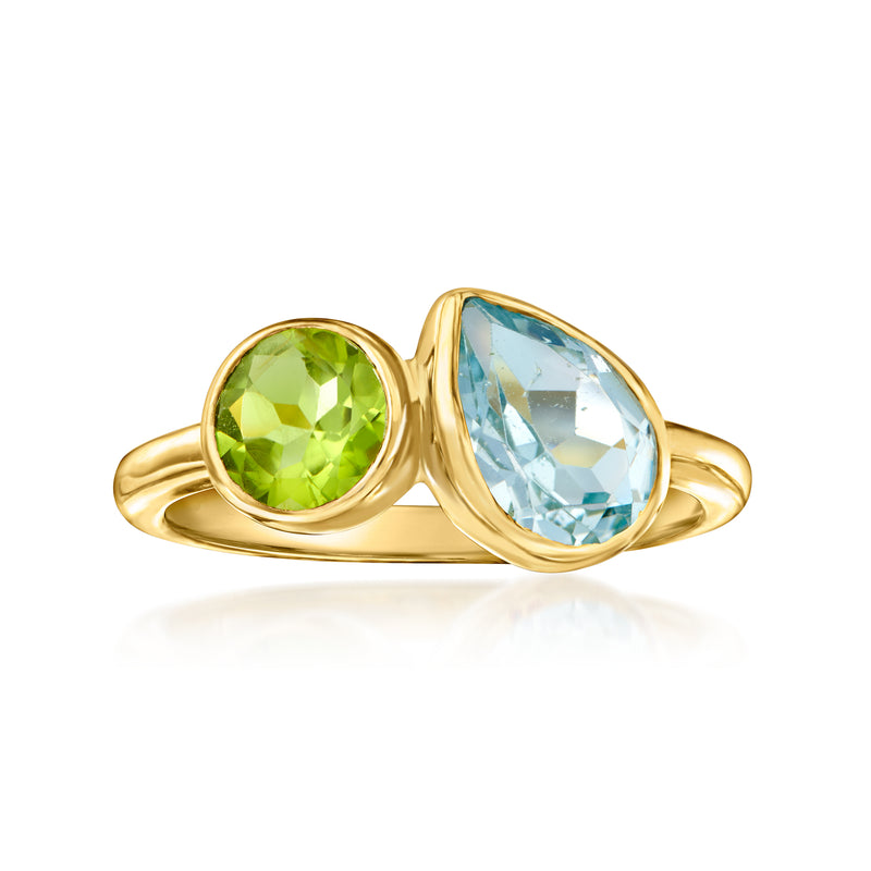 Gold toi et moi ring with round green peridot and light blue topaz stones