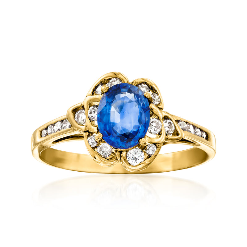 Vintage yellow gold ring with oval blue sapphire center and diamond halo