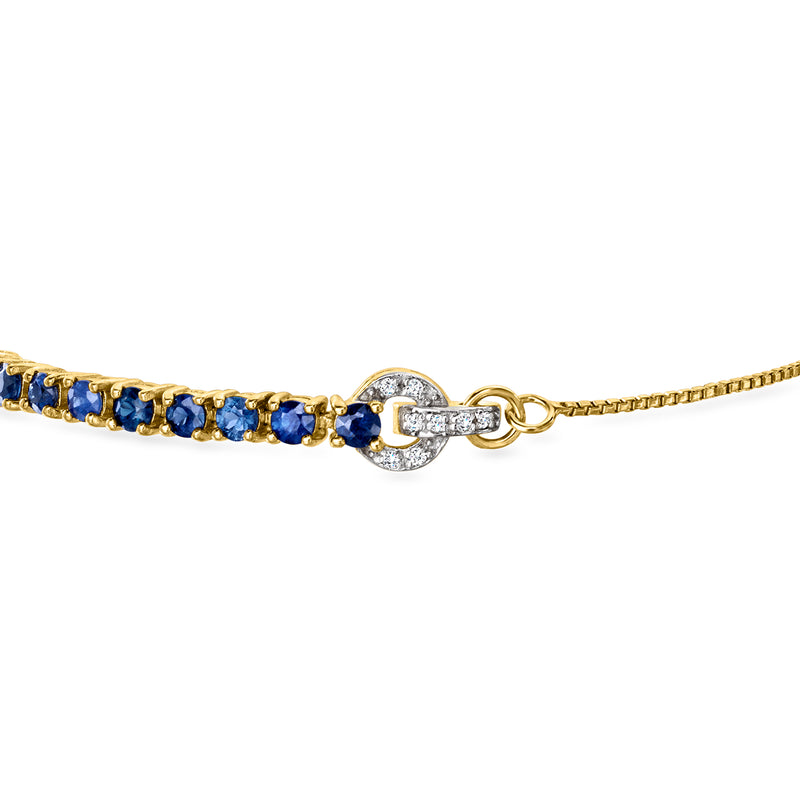 Gold sapphire bolo bracelet with white zircon halo charm and blue stone tennis row