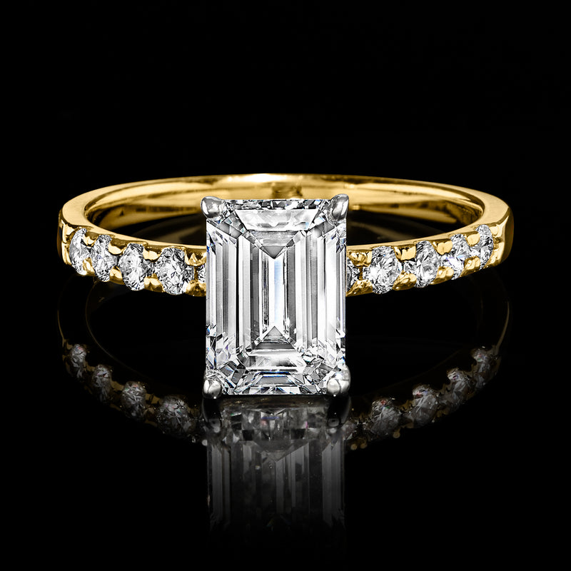 14kt yellow gold ring with emerald-cut diamond center and baguette side stones