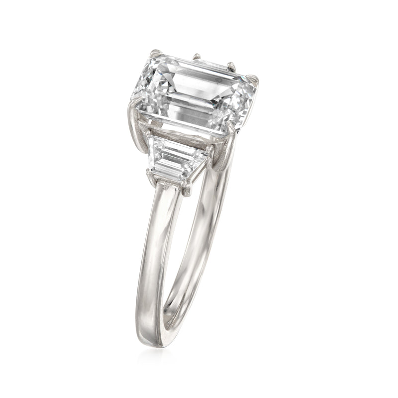 Emerald-cut center diamond with trapezoidal side stones on 14kt white gold band