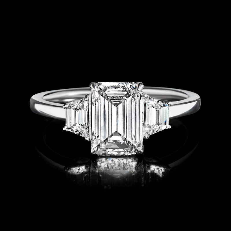 Emerald-cut center diamond ring with trapezoidal side stones, 14kt white gold