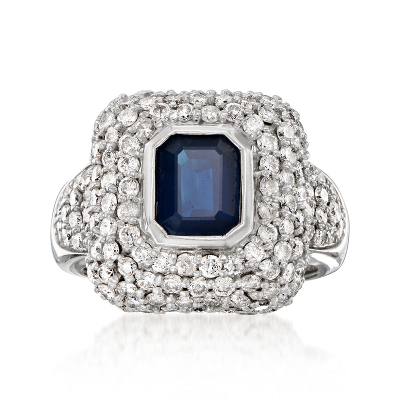 Vintage white gold ring with dark blue cushion sapphire and diamond halo