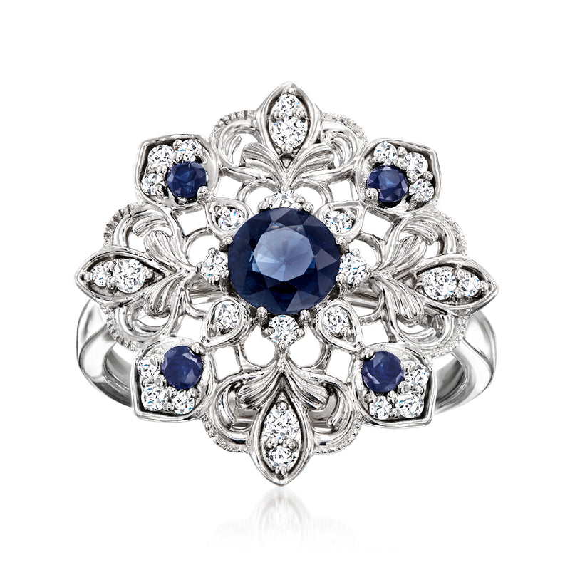 Sterling silver milgrain ring with round dark-blue sapphire center and diamond side stones