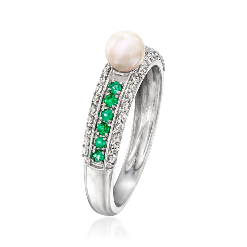 Sterling silver ring with raised white pearl, green gemstone band, and diamond border