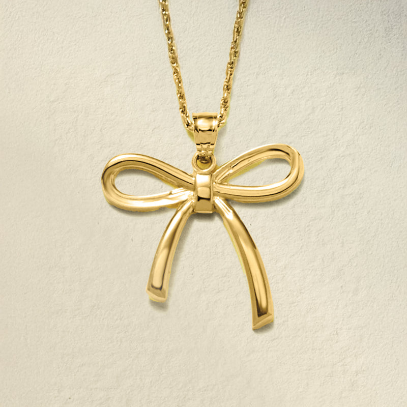 Yellow gold bow pendant on chain, draped ribbon loops and center knot