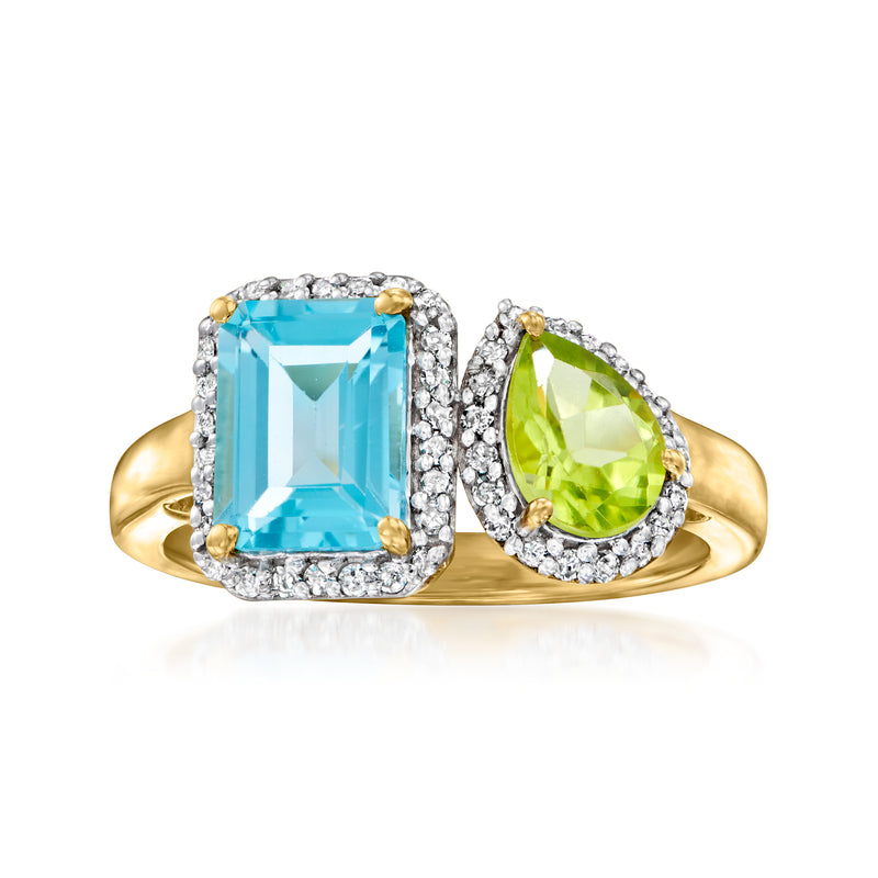 Gold toi et moi ring with blue rectangular topaz and green pear peridot, haloed accents.