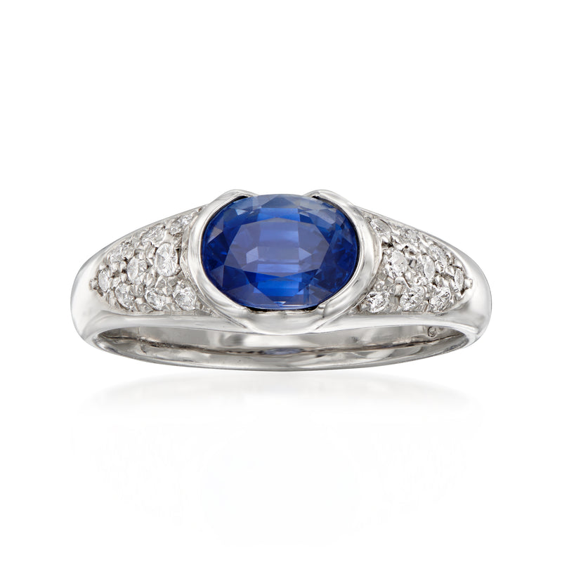Platinum sapphire and diamond ring with oval blue center stone and side diamond accents