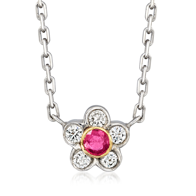 Flower pendant necklace with round pink ruby center, diamond accents, and link chain.