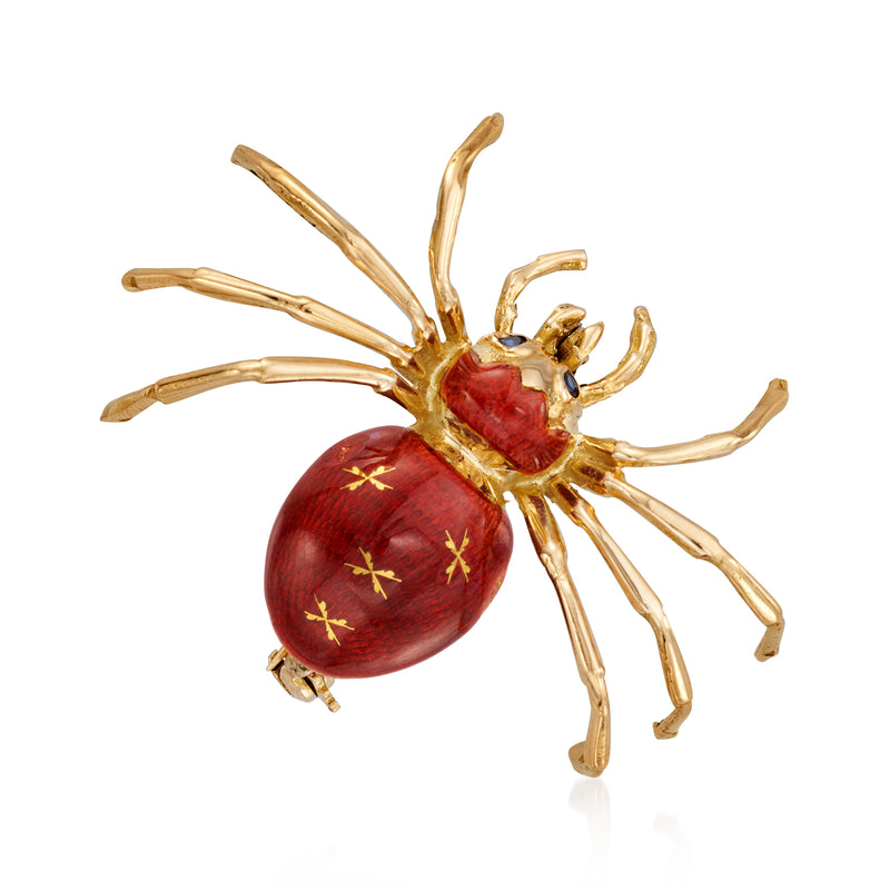 Vintage gold spider pin with red enamel abdomen and blue sapphire eyes, star-like accents