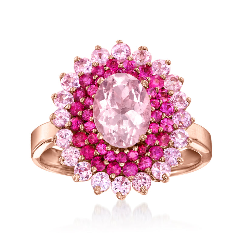 14kt rose gold ring with oval pink gemstone and halo of pink sapphires and rubies