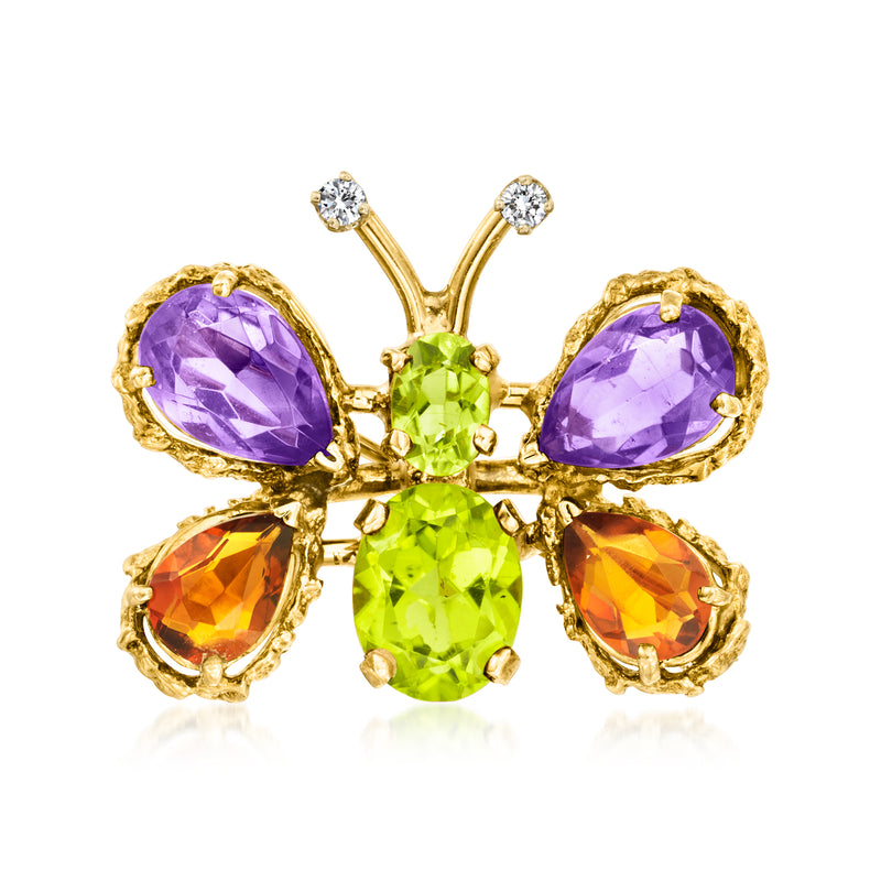Gold butterfly pin with purple, orange and green gemstone drops and diamond accents